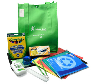 Various school supplies like pencils, glue and notebooks surround a green cloth bag with the School Start logo on it.